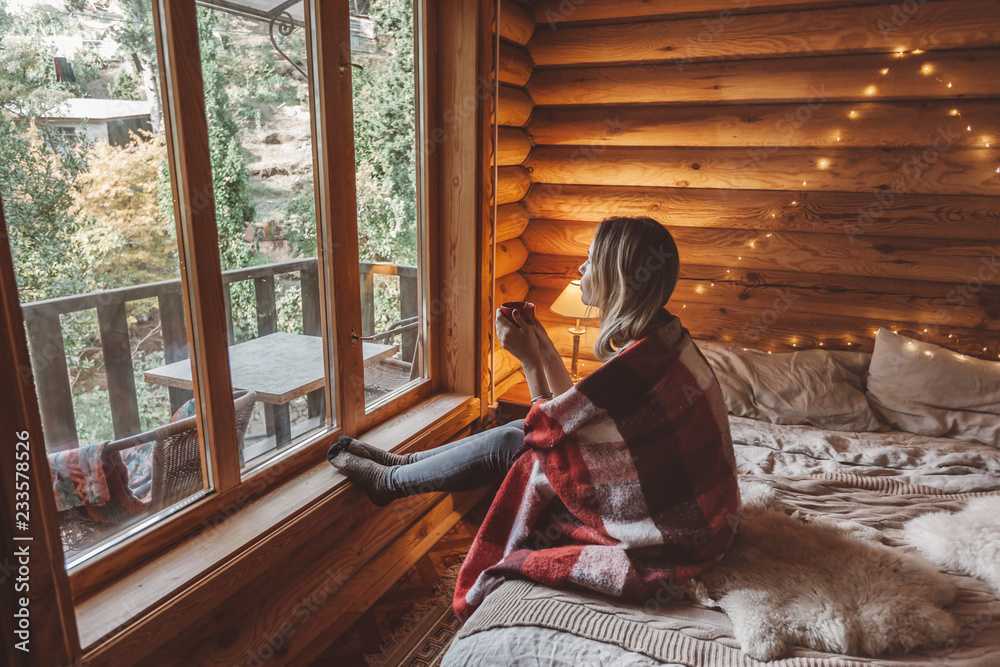 a woman sitting in a blanket on a cozy afternoon in tahoe with clean windows